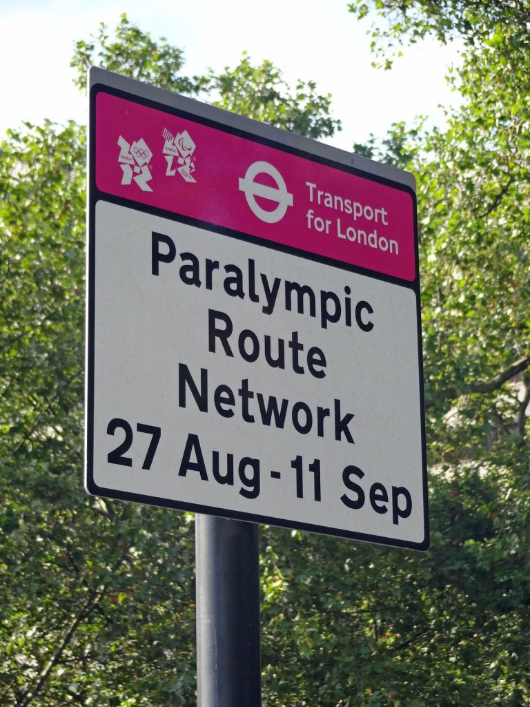 Sign with the London 2012 logo saying "Paralympic Route Network 27 Aug - 11 Sep"