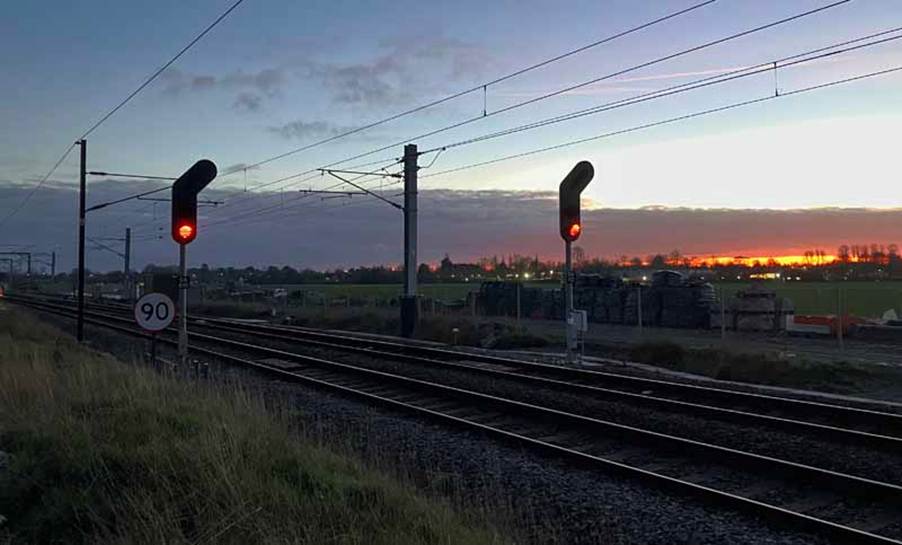 Two red signals, at sunset